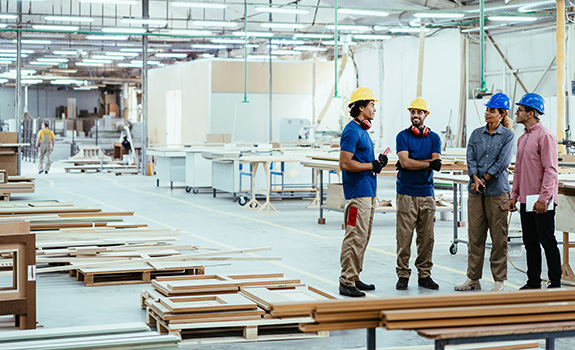 Staff talking together in modern timber factory