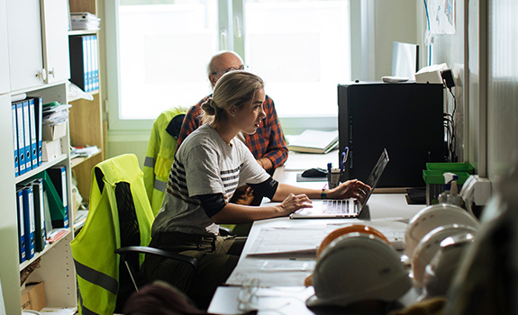 young female working in her office at the construction site