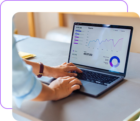 Business professional analyzing financial data on a laptop at office desk